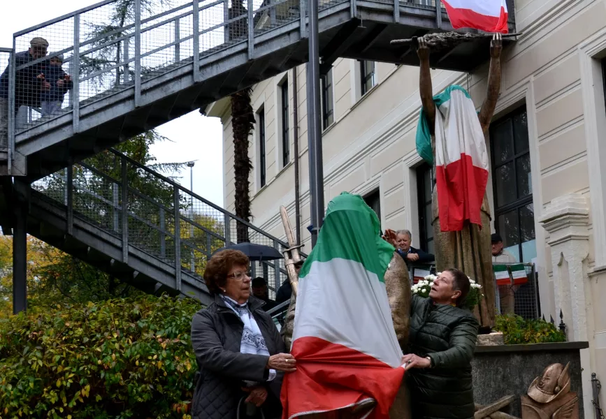 Un'immagine significativa: mentre le madrine Giovanna Paoletti e Paola Degiovanni scoprono il monumento, un nonno e un bambino guardano la scena dall'alto