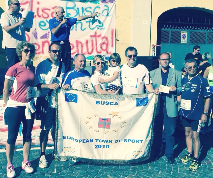 Pronti al via. Sul palco Giulio Botto e Giangi Giordano. Sotto da sinistra l'assessora Carla Eandi, il consigliere comunale Diego Bressi,  l'assessore Gian Franco Ferrero,  Elisa Rigaudo con la figlia, il sindaco Marco Gallo, il presidente Anpi Busca Mario Berardo, Il presidente della Podistica Buschese Angelo Pasero