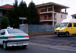 Uno scuolabus in uscita dal cortile della scuola